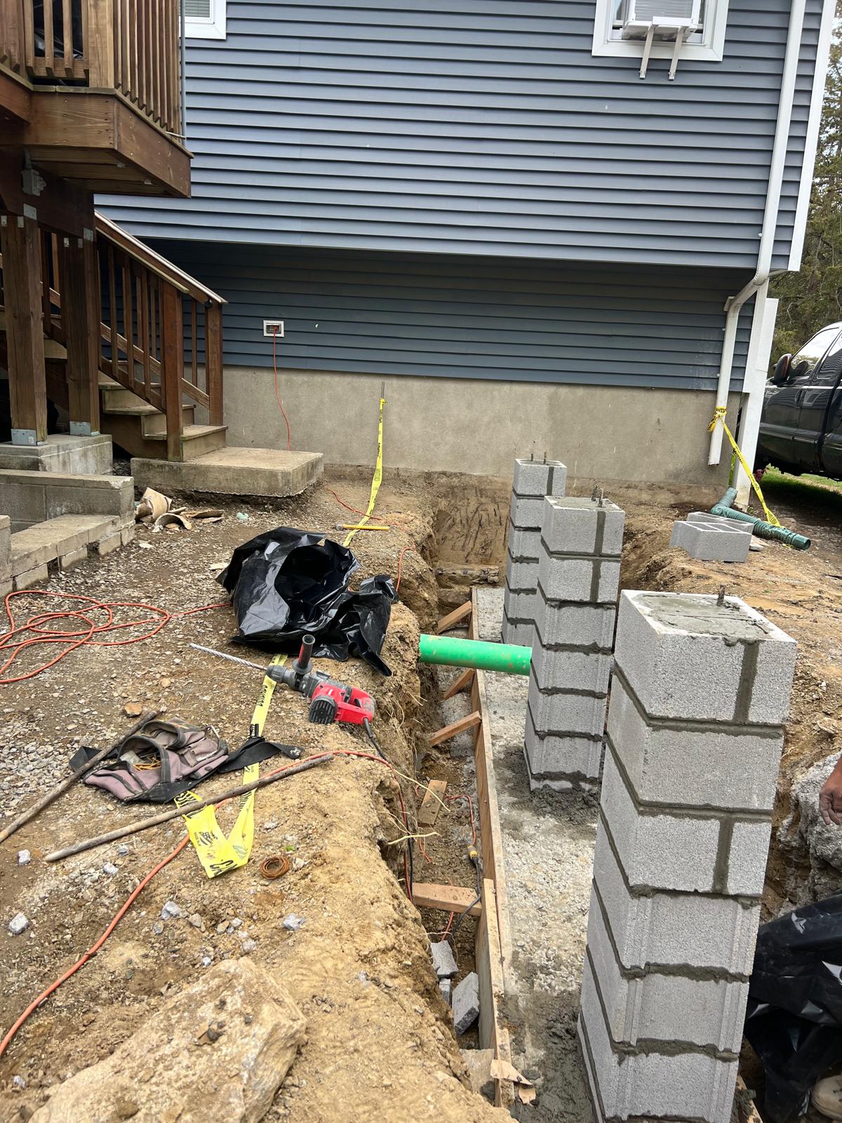 Concrete blockwork and foundation work beside a home